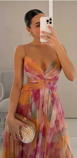 Woman wearing a floral tulle maxi dress with thin straps
