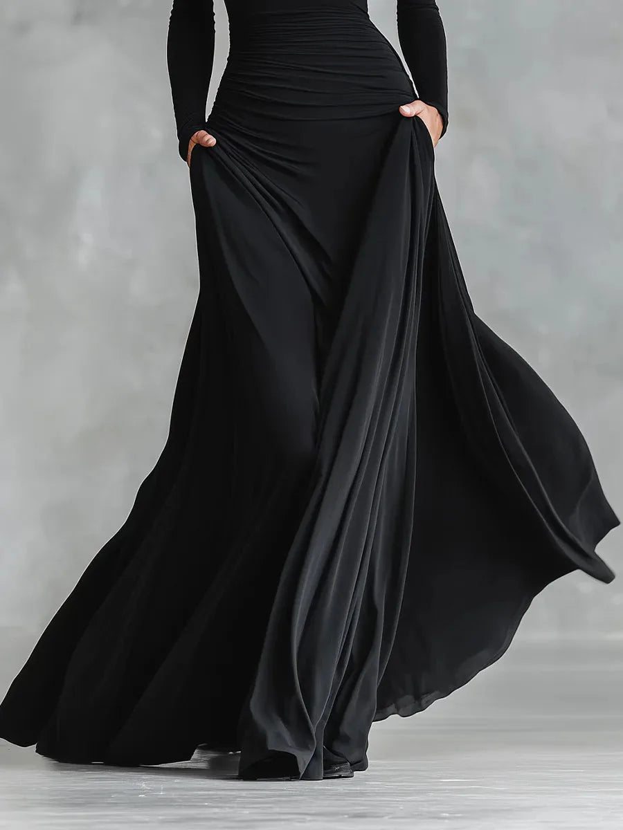 Women's black boat-neck maxi dress with flowing skirt, full-length view of the flowing skirt