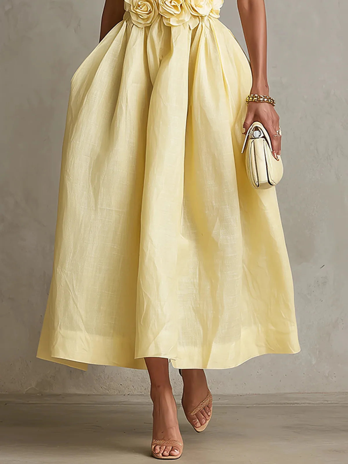 Women's yellow strapless midi dress with 3D flower bodice, side view of the full skirt