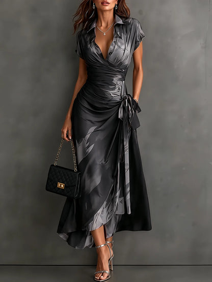 Women's abstract print wrap midi dress with tie waist, grey, front view with handbag