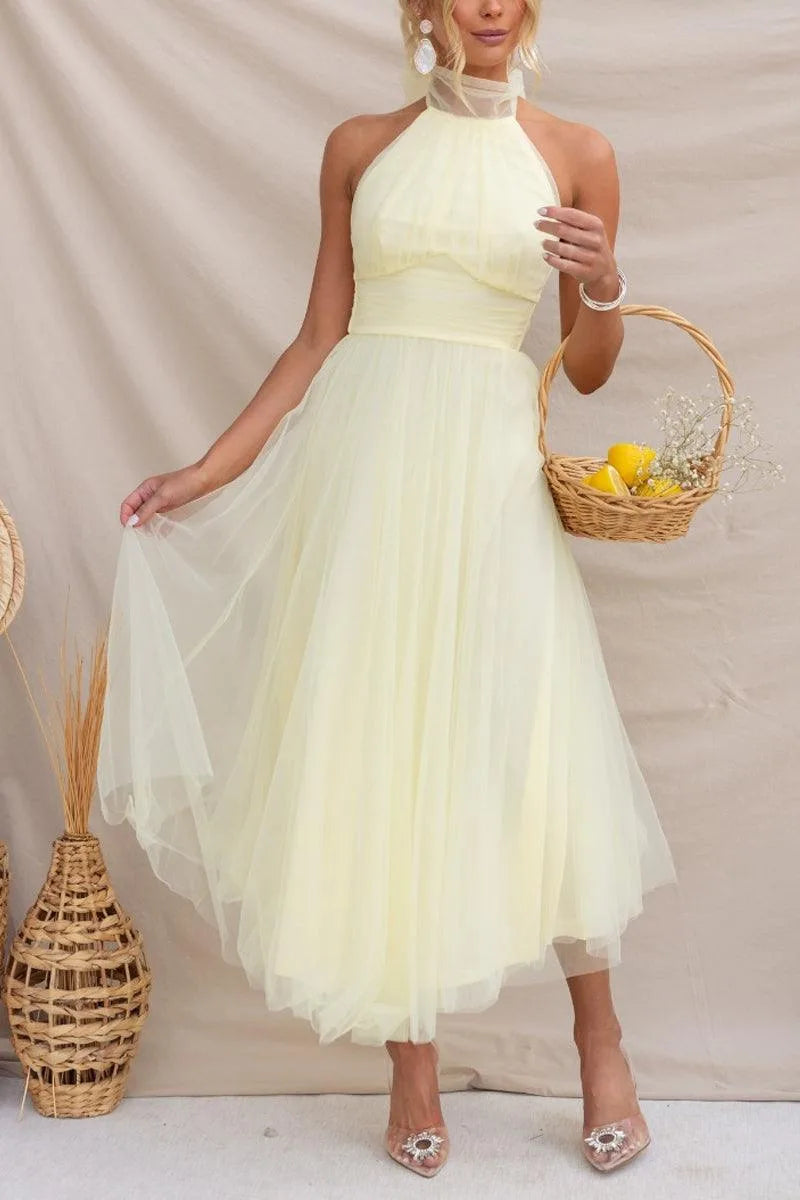 Women's adjustable-tie halter maxi dress with flowing skirt, yellow, styled with a basket