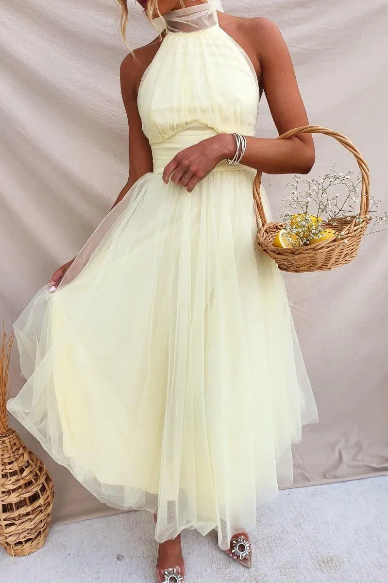 Women's adjustable-tie halter maxi dress with flowing skirt, yellow, styled with a basket