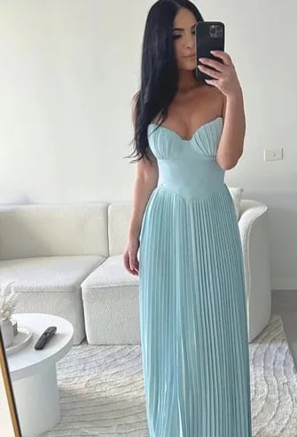 Woman wearing a light blue pleated bustier maxi dress
