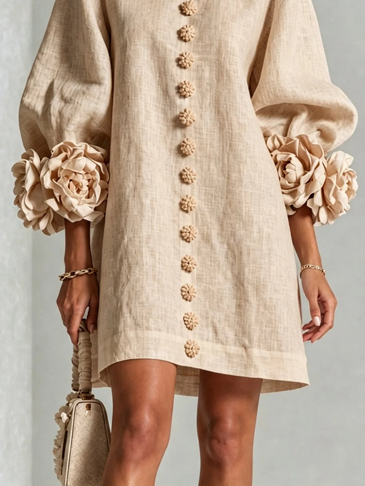 Women's beige button-front mini dress with floral rose cuffs, close-up of the rose cuff