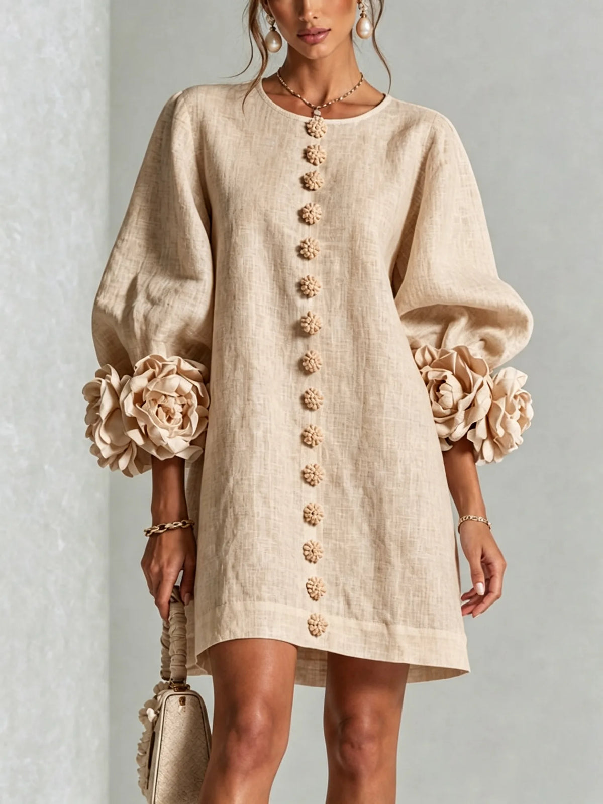 Women's beige button-front mini dress with floral rose cuffs, front view