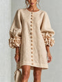 Women's beige button-front mini dress with floral rose cuffs, front view