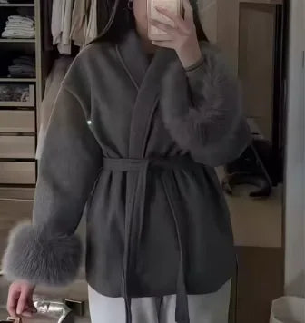 Women's belted wrap coat with fur-style cuffs, dark grey, worn in a mirror