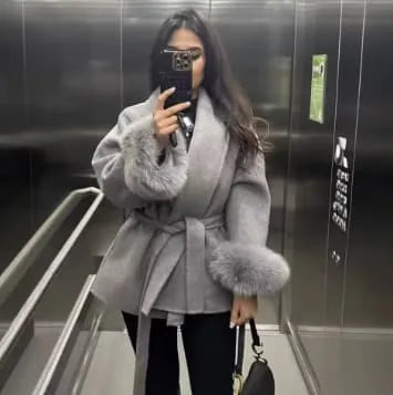 Women's belted wrap coat with fur-style cuffs, light grey, worn in a mirror