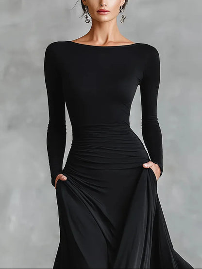 Women's black boat-neck maxi dress with flowing skirt, close-up of the boat neckline