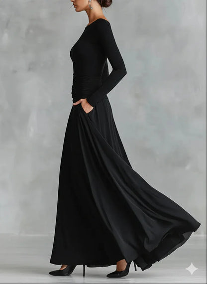 Women's black boat-neck maxi dress with flowing skirt, three-quarter view