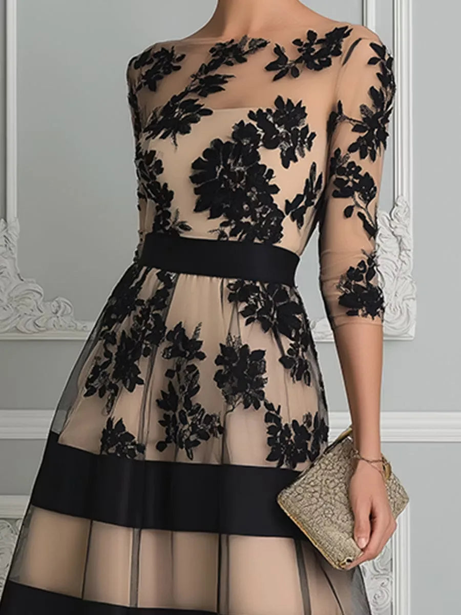 Women's black floral lace midi dress with banded skirt, close-up of the floral lace bodice and waist band
