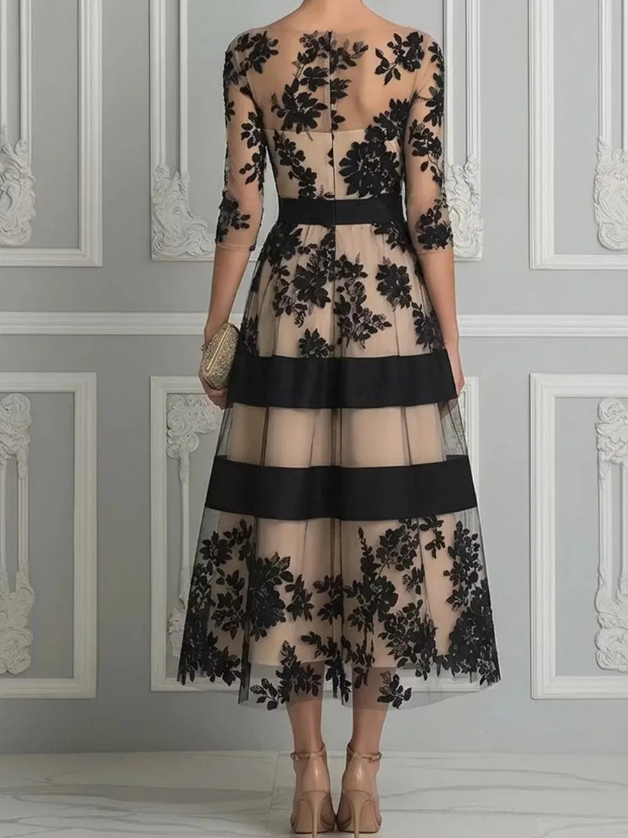 Women's black floral lace midi dress with banded skirt, full-length view