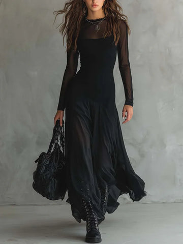 Women's black maxi dress with sheer layers and long sleeves, front view with handbag