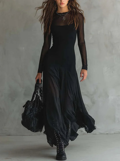 Women's black maxi dress with sheer layers and long sleeves, front view with handbag
