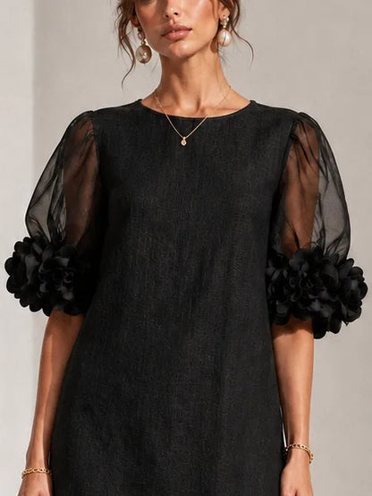 Women's black puff-sleeve mini dress with floral rose cuffs, close-up of the sleeves and neckline