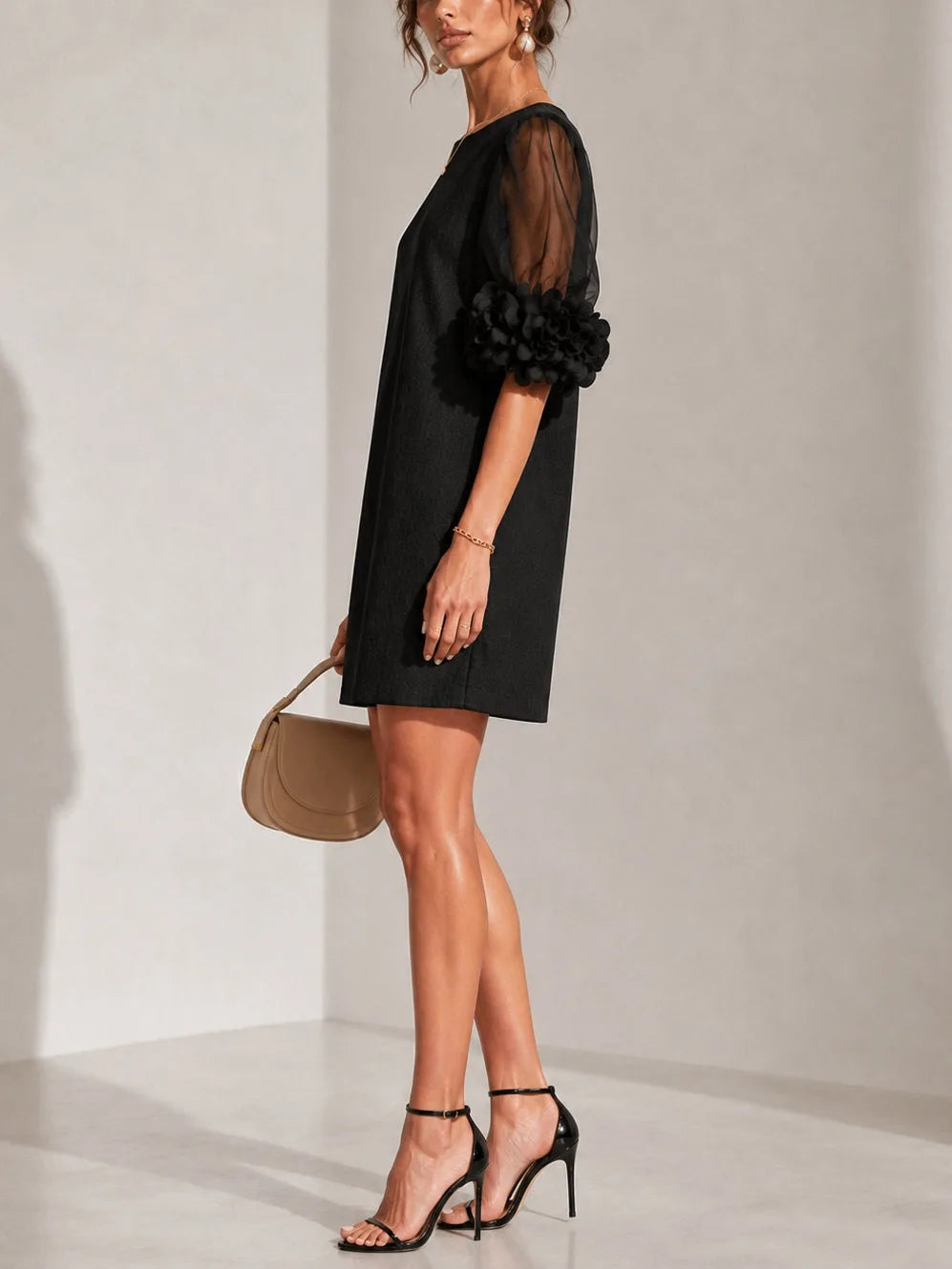 Women's black puff-sleeve mini dress with floral rose cuffs, side view