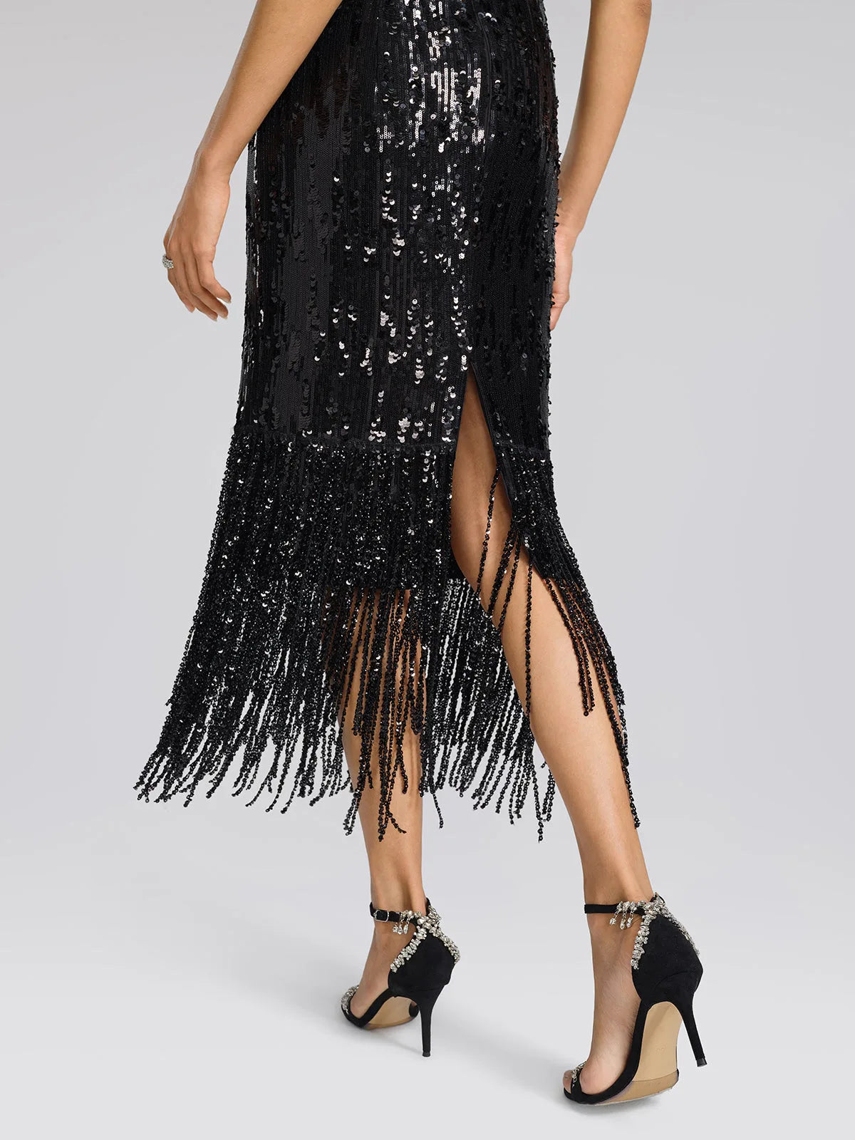 Women's black sequin fringe midi skirt with slit, close-up of the back slit