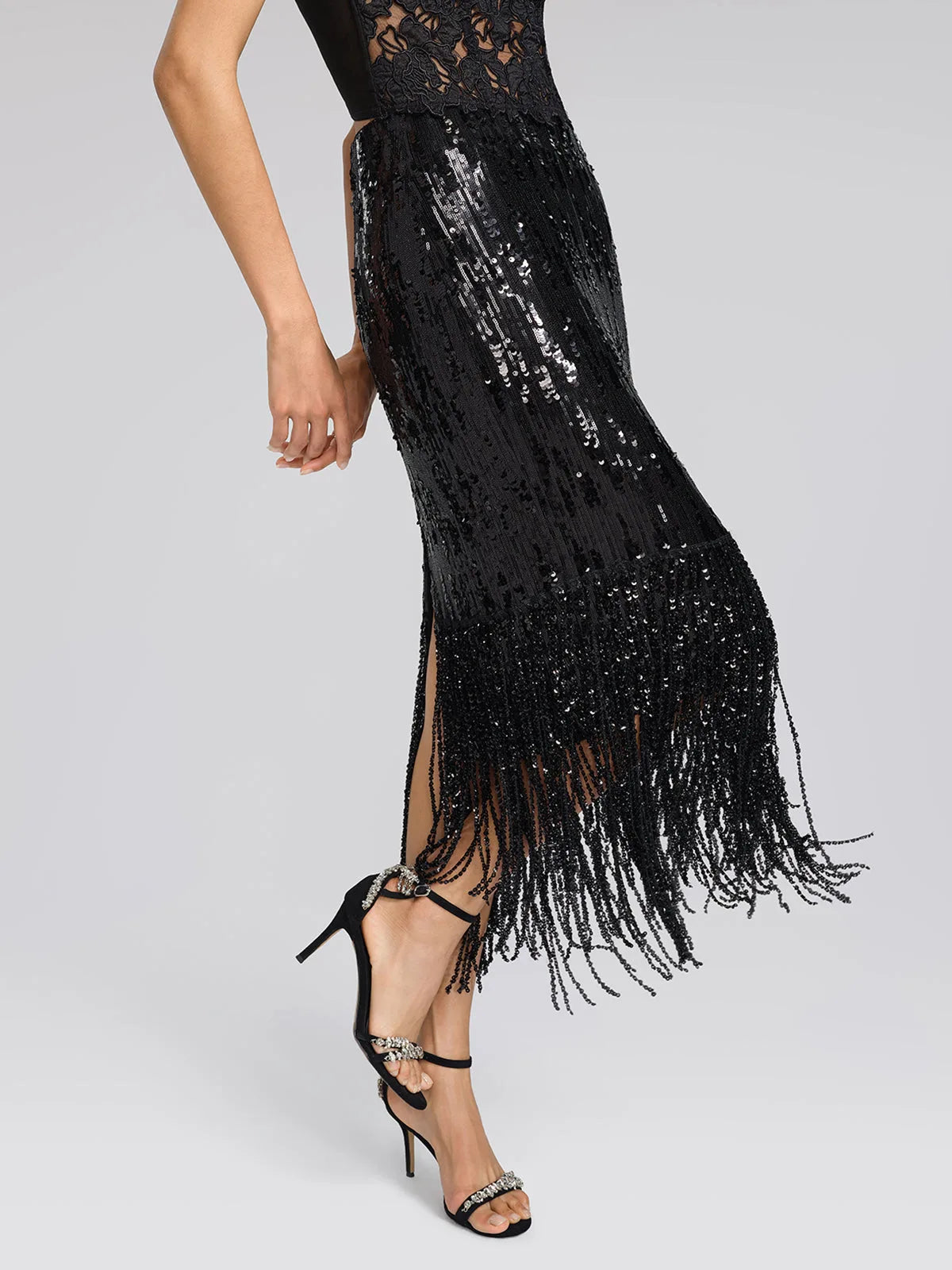 Women's black sequin fringe midi skirt with slit, side view in motion