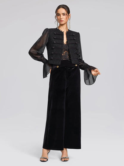 Women's black sequin fringe midi skirt with slit, styled with a black jacket and trousers