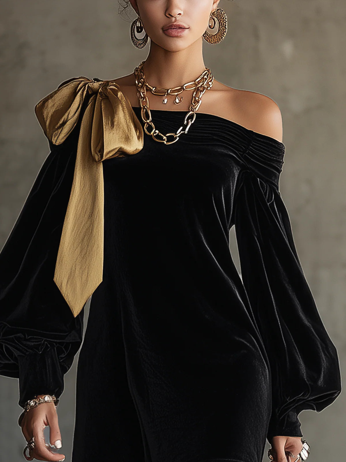Black velvet mini dress with asymmetric gold bow