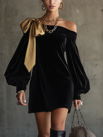 Black velvet off-shoulder mini dress with gold bow