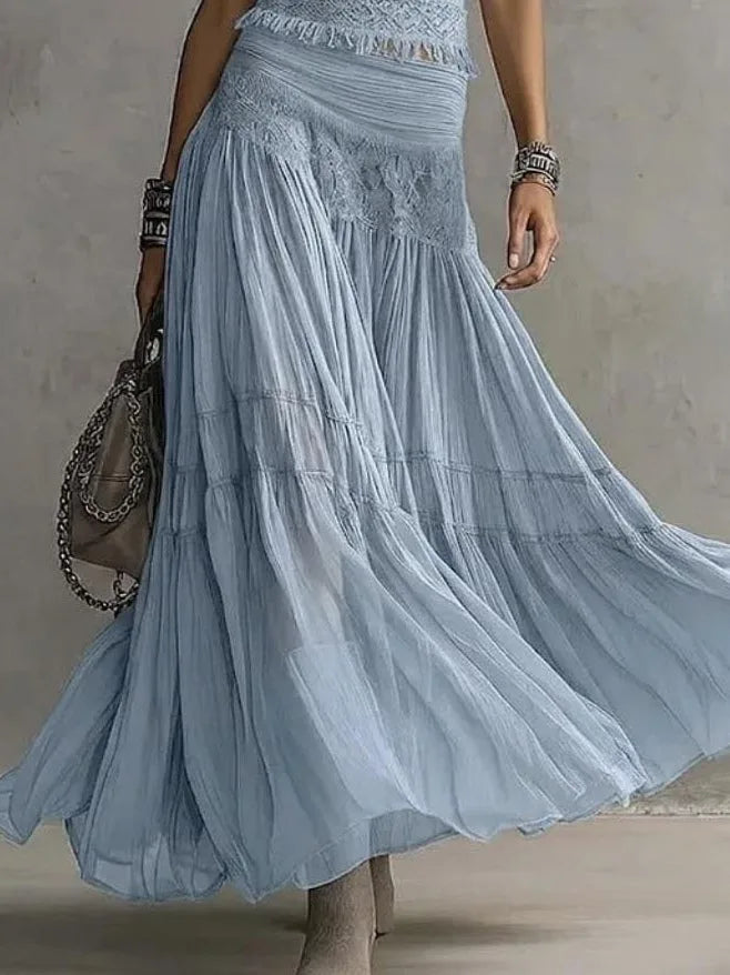Women's blue lace-paneled top and pleated maxi skirt set, close-up of the pleated skirt