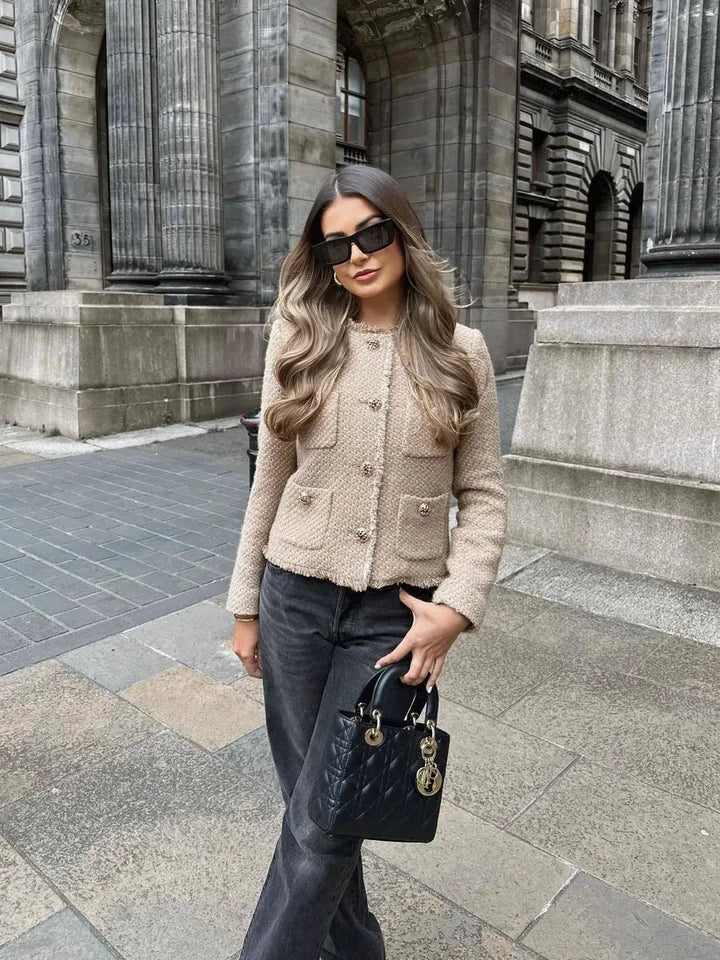 Women's cropped boxy beige jacket with gold-tone buttons, styled with a long skirt