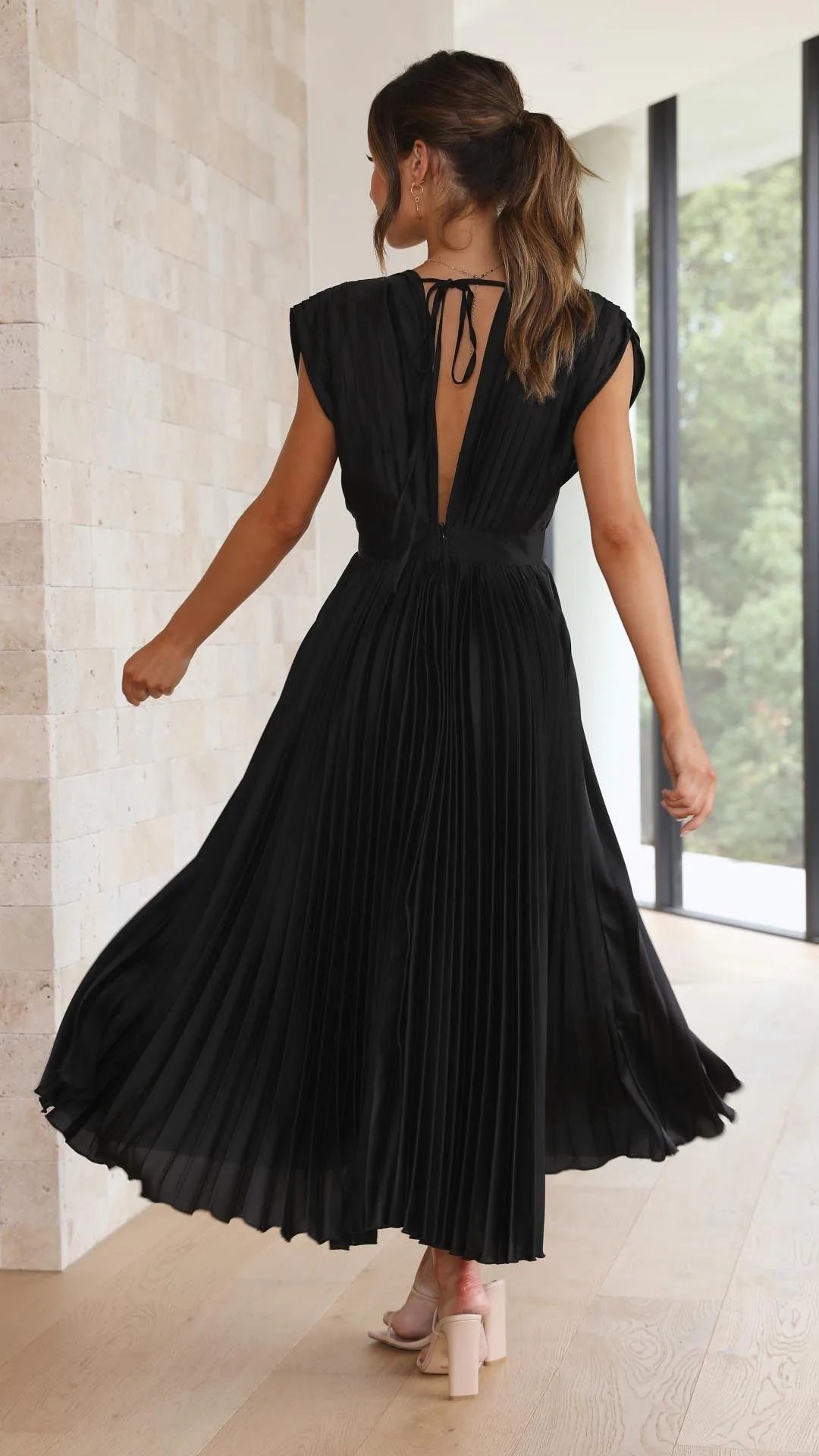 Women's draped V-neck pleated midi dress with cap sleeves, black, back view with keyhole detail