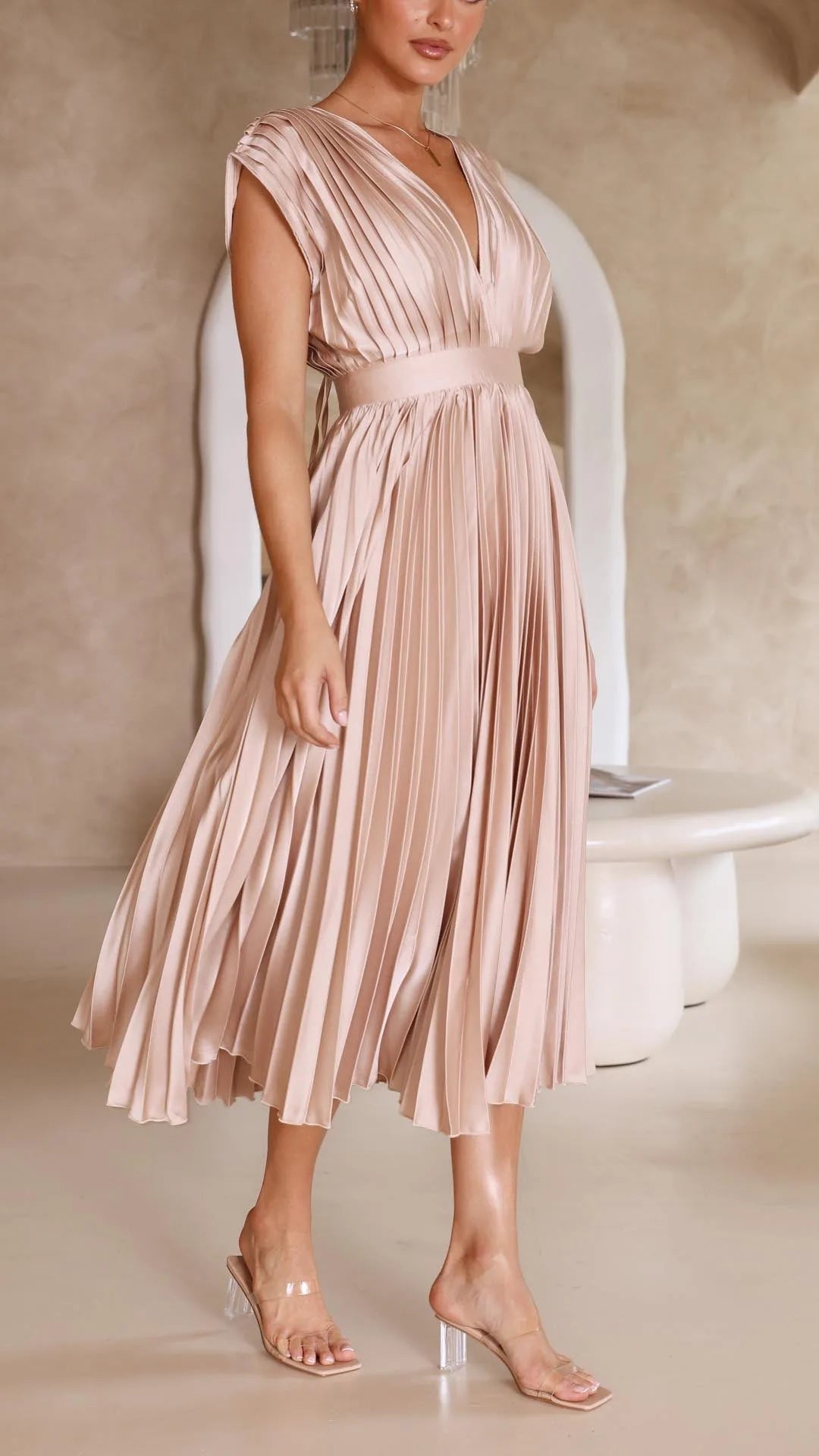 Women's draped V-neck pleated midi dress with cap sleeves, light pink, skirt in motion