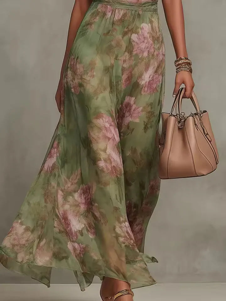 Women's floral halter maxi dress with gathered waist, side view showing the flowing skirt