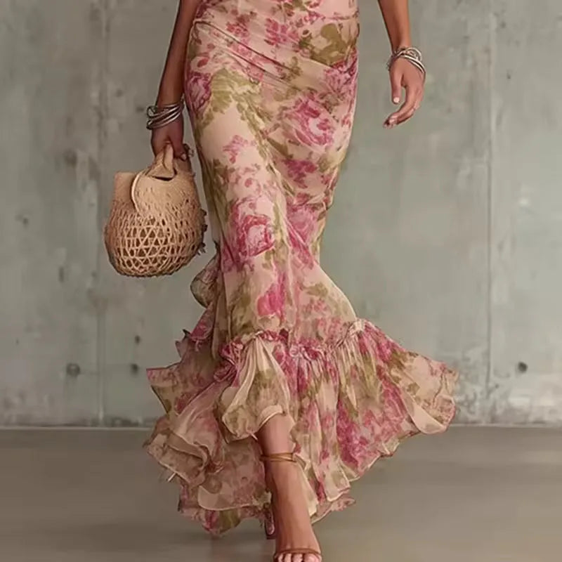 Women's pink floral maxi dress with high neck and puff sleeves, side view of the mermaid skirt