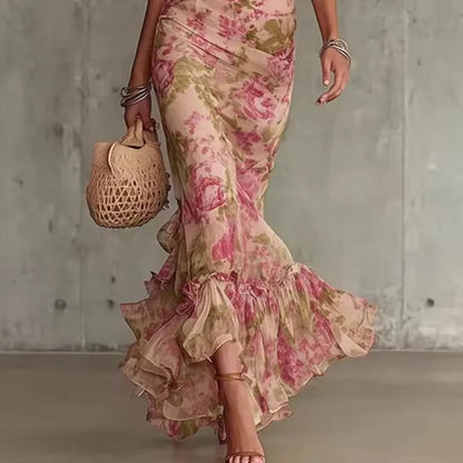 Women's pink floral maxi dress with high neck and puff sleeves, side view of the mermaid skirt