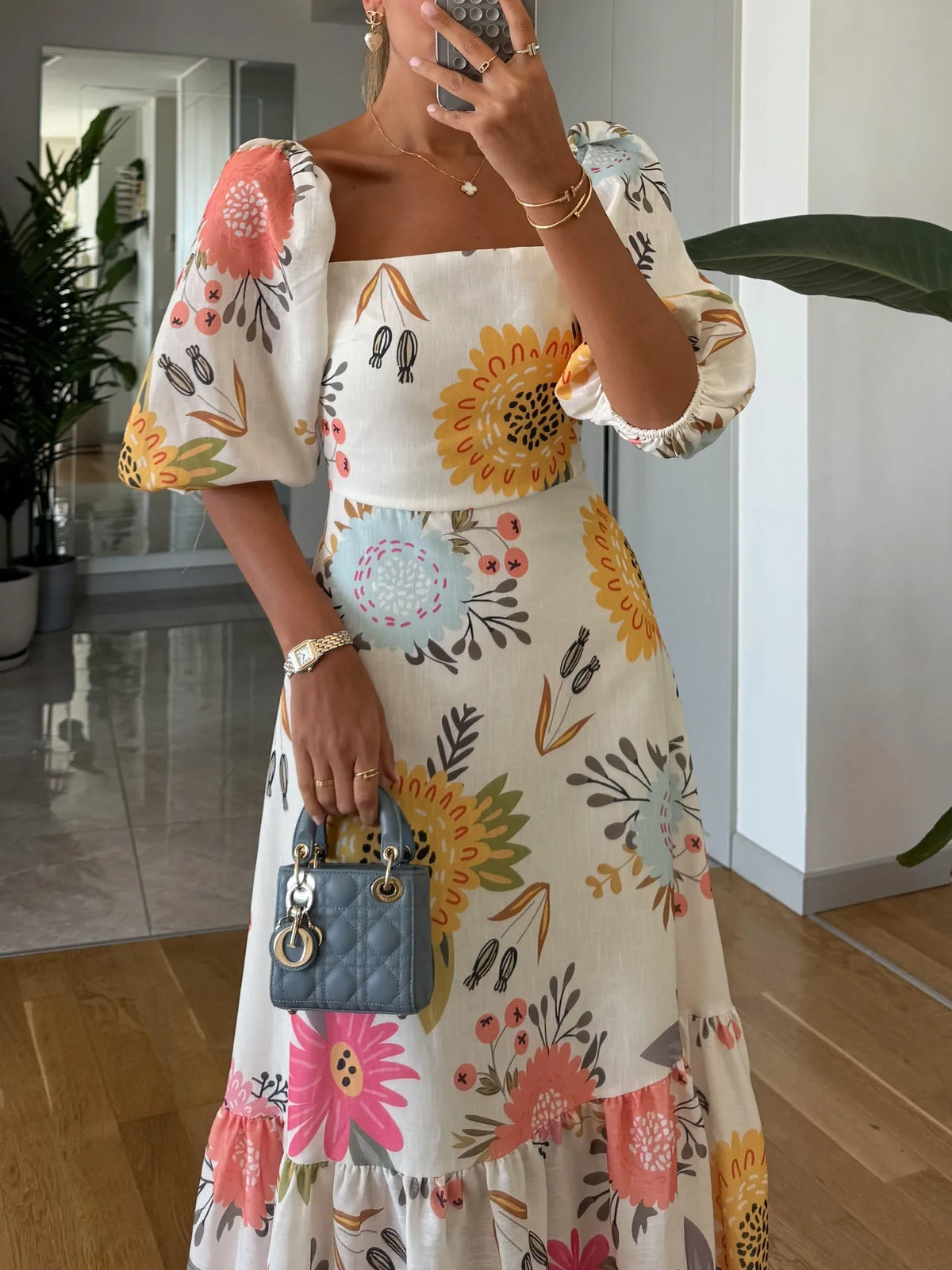 Women's floral midi dress with square neck and puff sleeves, close-up of the bodice and sleeves