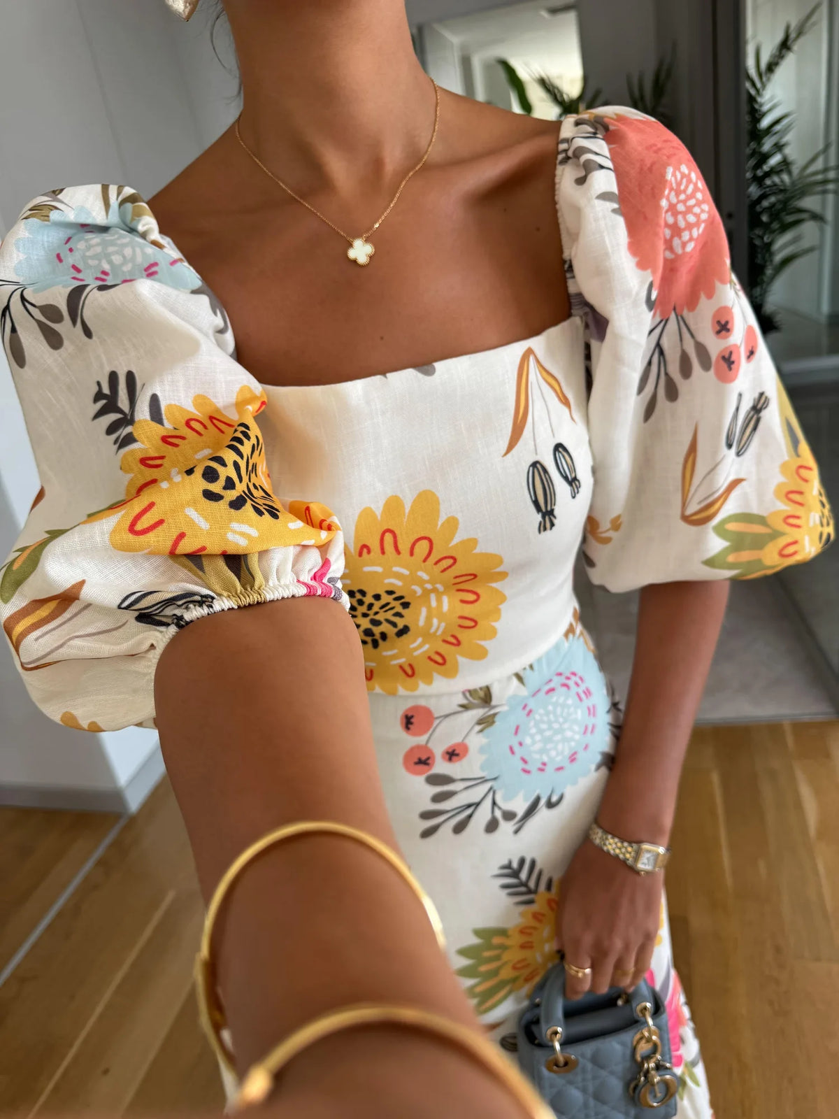 Women's floral midi dress with square neck and puff sleeves, close-up of the square neckline and puff sleeve