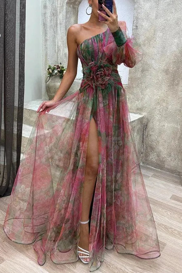 Women's floral print one-shoulder maxi dress with slit and flower detail, red, front view in a mirror