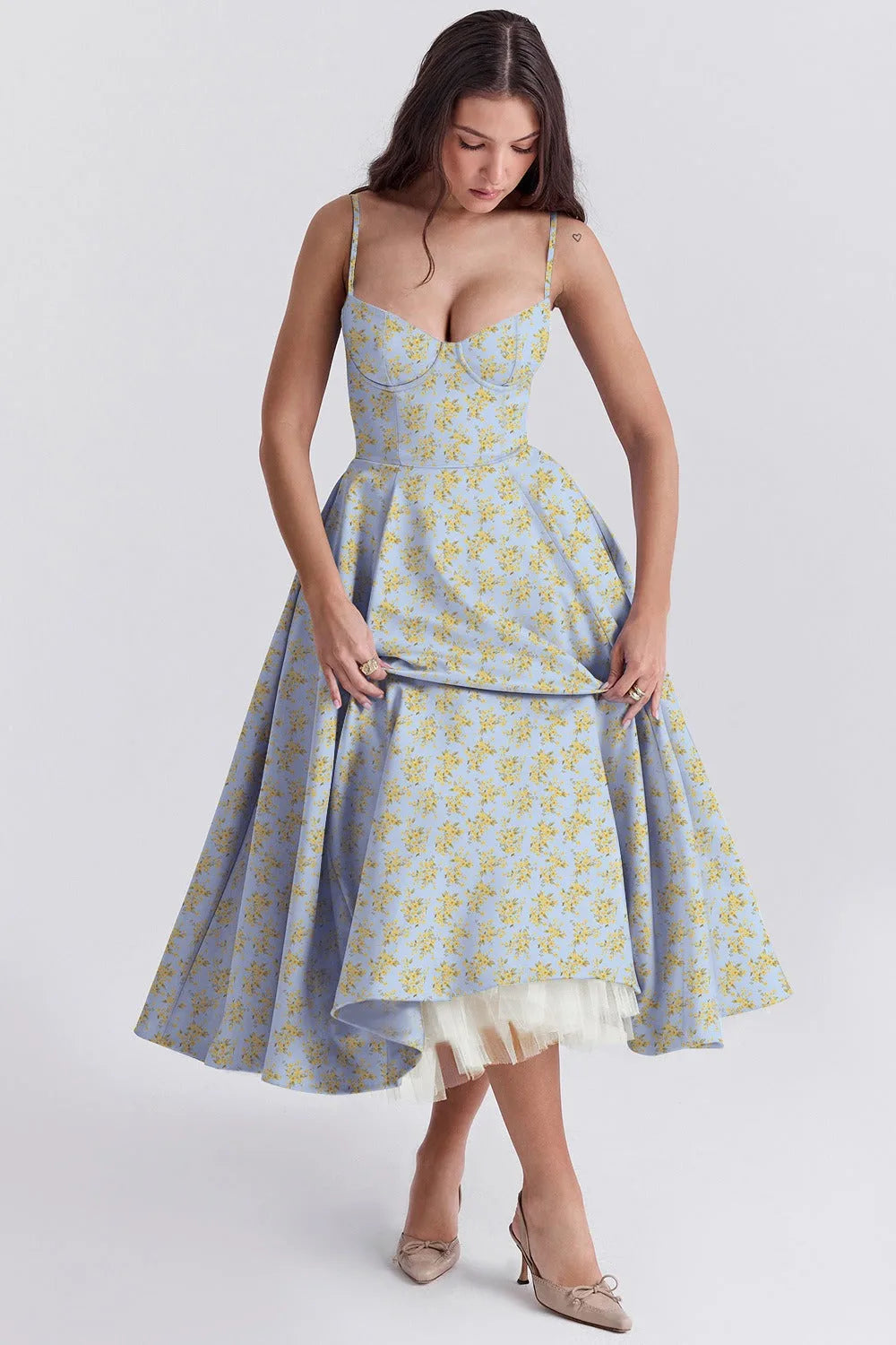 Women's floral sweetheart midi dress with full skirt, light blue, lifting the skirt