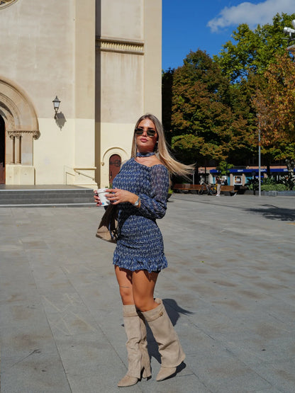 Women's fold-over knee-high boots with gold buckle, beige, worn with a patterned mini dress