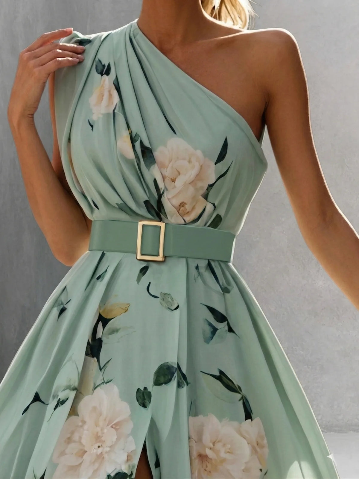 Women's green floral one-shoulder maxi dress with slit, close-up of the one-shoulder neckline and belt