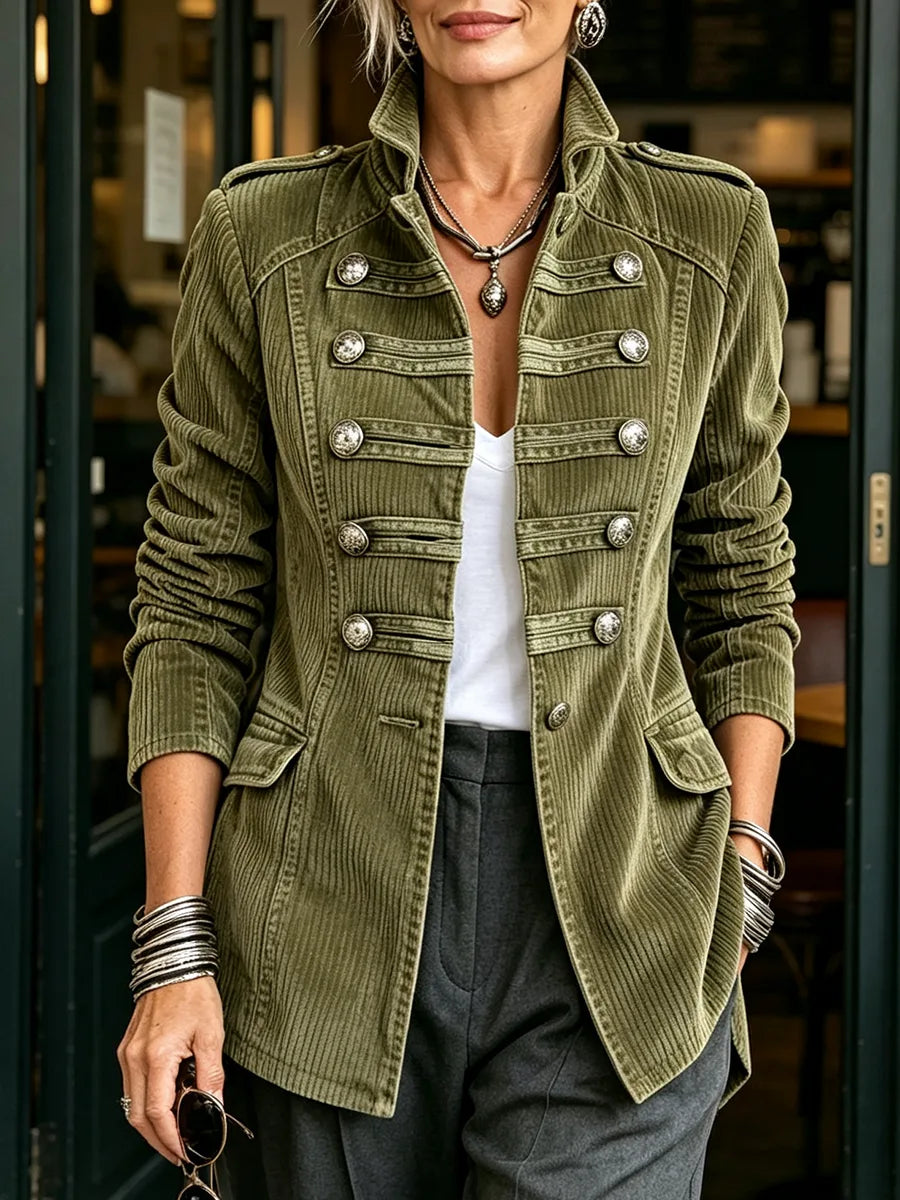 Women's olive military-style jacket with double row of metal buttons, front view in a doorway