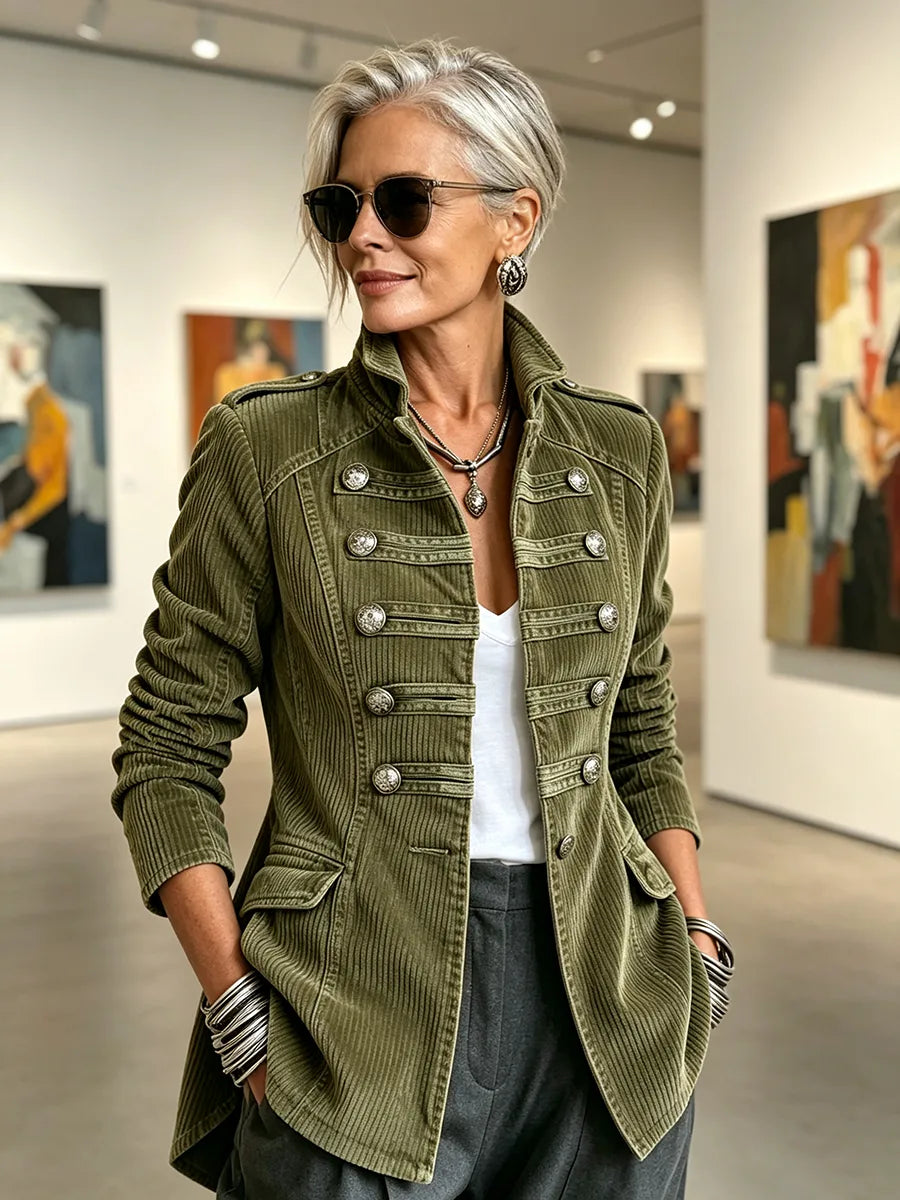 Women's olive military-style jacket with double row of metal buttons, styled in a gallery