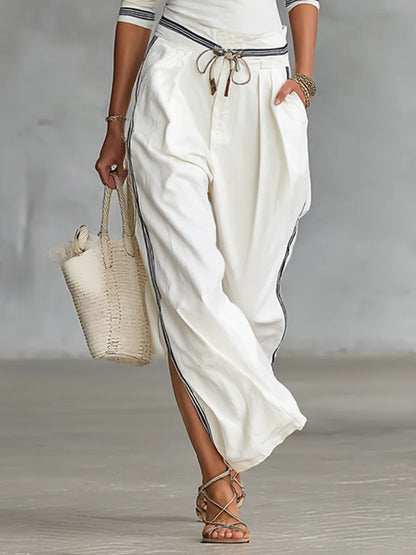 Women's mock-neck top and wide-leg drawstring pants set, white, side view showing the wide leg