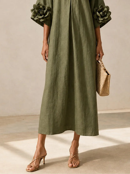 Women's olive green midi dress with floral appliqué sleeves, full-length back view