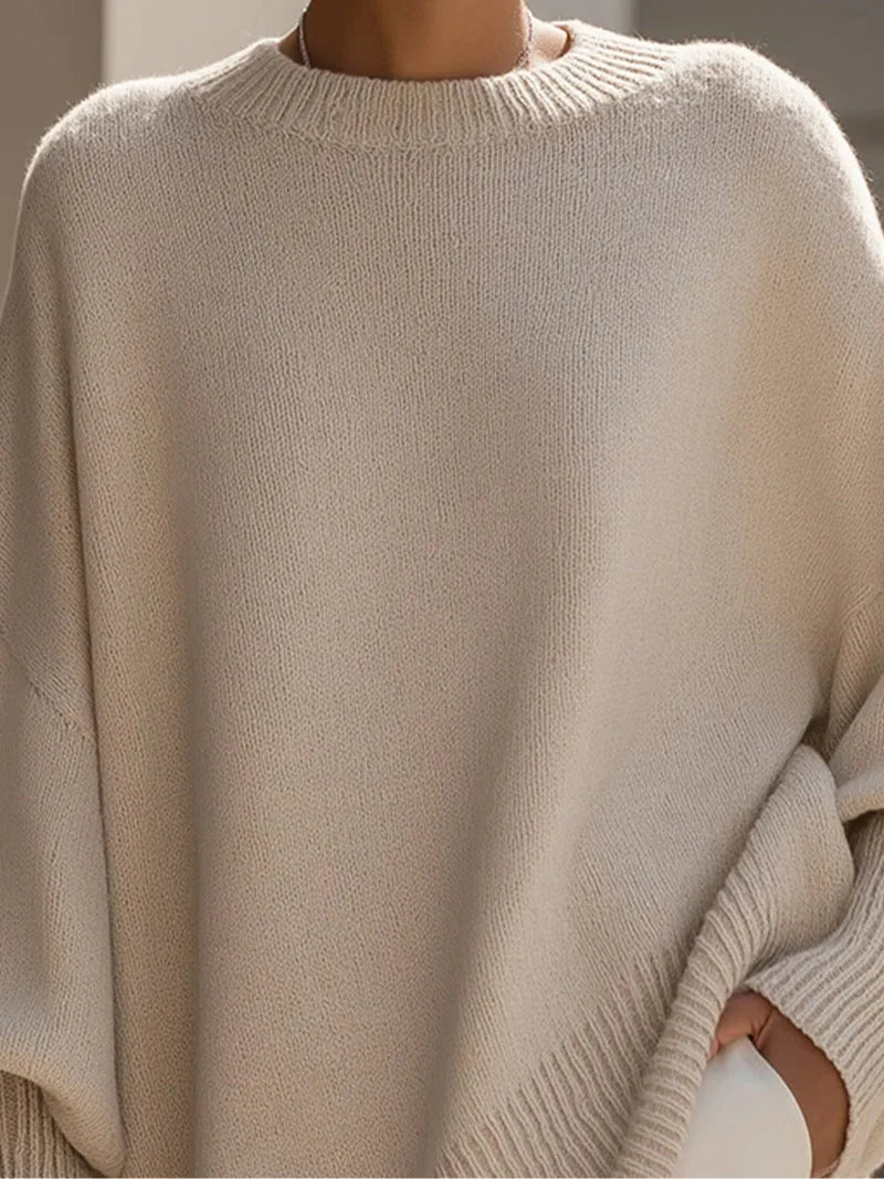Women's oversized batwing sweater with side slits, cream, close-up of the neckline