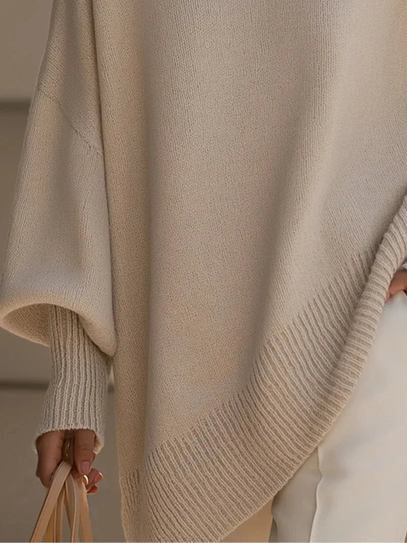 Women's oversized batwing sweater with side slits, cream, close-up of the side slit and sleeve