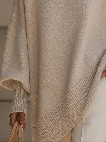 Women's oversized batwing sweater with side slits, cream, close-up of the side slit and sleeve
