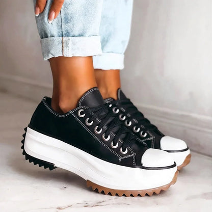 Women's platform sneakers with cushioned sole, black, worn with jeans