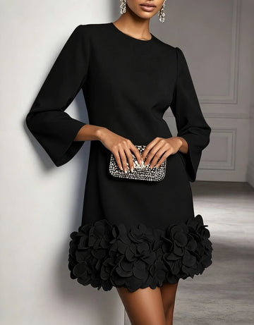 Women's round-neck shift mini dress with 3D floral hem, black, front view with clutch