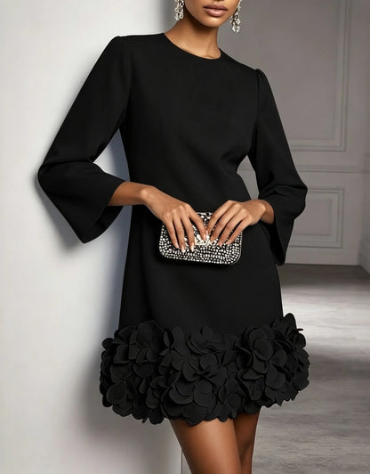 Women's round-neck shift mini dress with 3D floral hem, black, front view with clutch