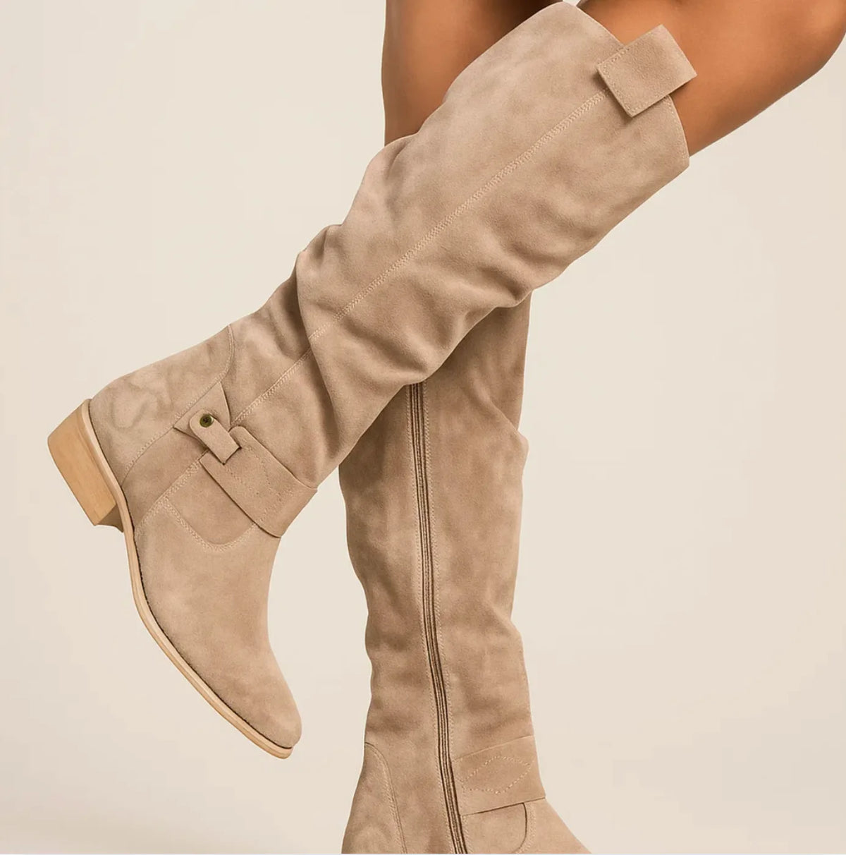 Women's slouchy knee-high boots with buckle strap, beige, side view worn