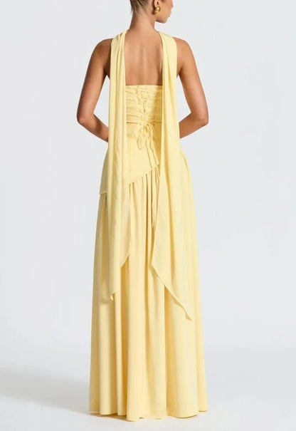 Women's strapless maxi dress with high slit and draped sash, yellow, back view with bow